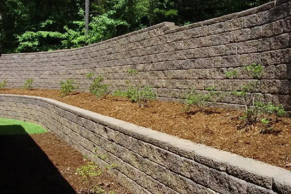 Curved block retaining wall with a planted bed on top